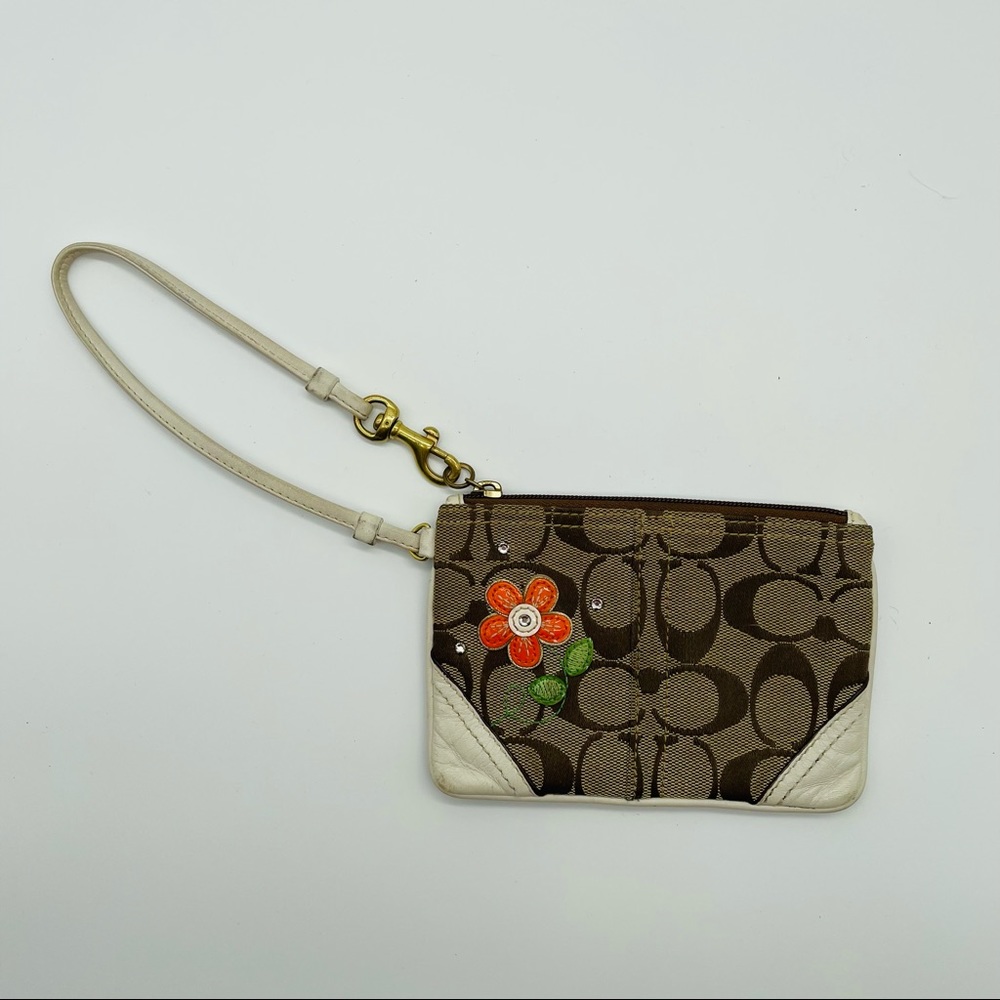 Coach brown signature wristlet with orange flower detail